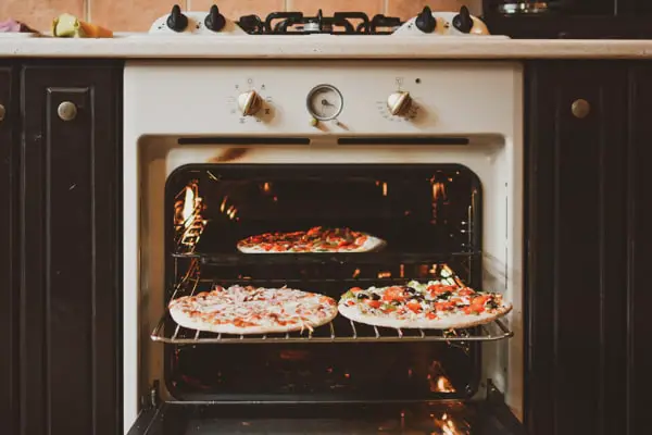 Getting Pizzas Ready In An Oven